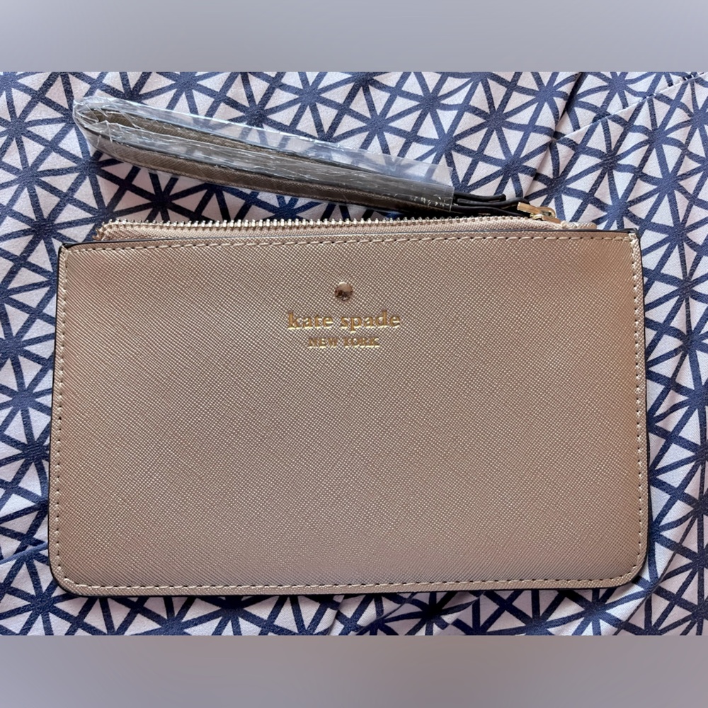 Small and slim Kate Spade wristlet in a very pretty gold textured material.